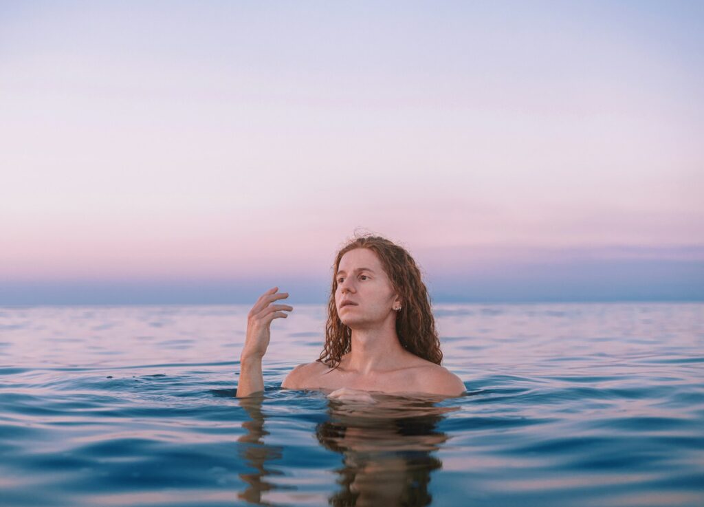 A woman floating in the water with her hand up